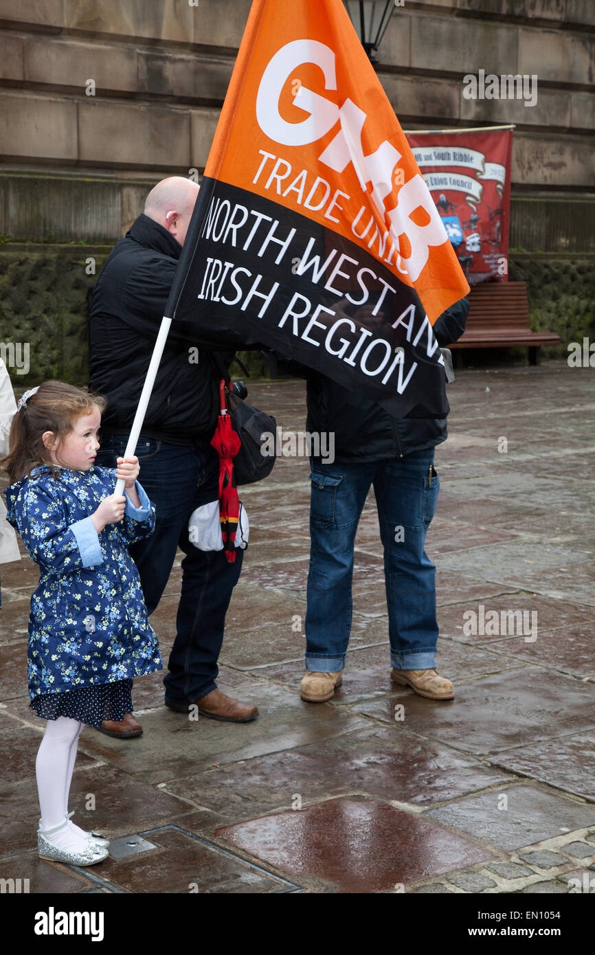 Preston, Lancashire, UK 25th April 2015. Ella Flangan, 6 years old at the International Workers Memorial Day event with memorial service, March & rally to acknowledge those killed, injured and made ill through work each year.  The Commemoration and Campaign at Preston Flag market this year is to remember the dead and fight for the living with disease and illness generated by hazardous substances such as Asbestos. Credit:  MarPhotographics/Alamy Live News. Stock Photo