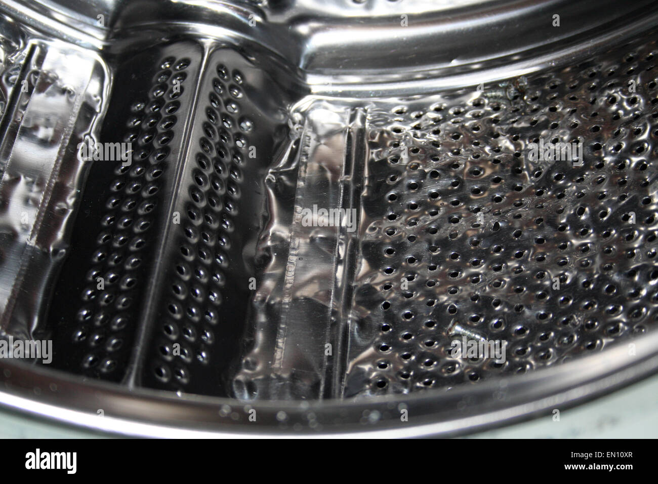 Close-up of a damaged washing machine drum. Stock Photo