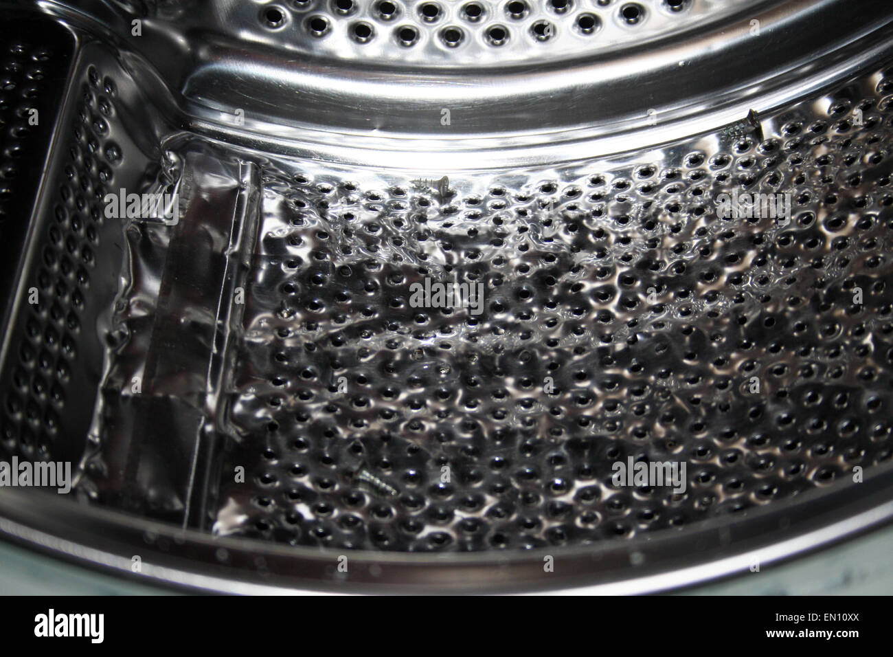 Close-up of a damaged washing machine drum Stock Photo - Alamy