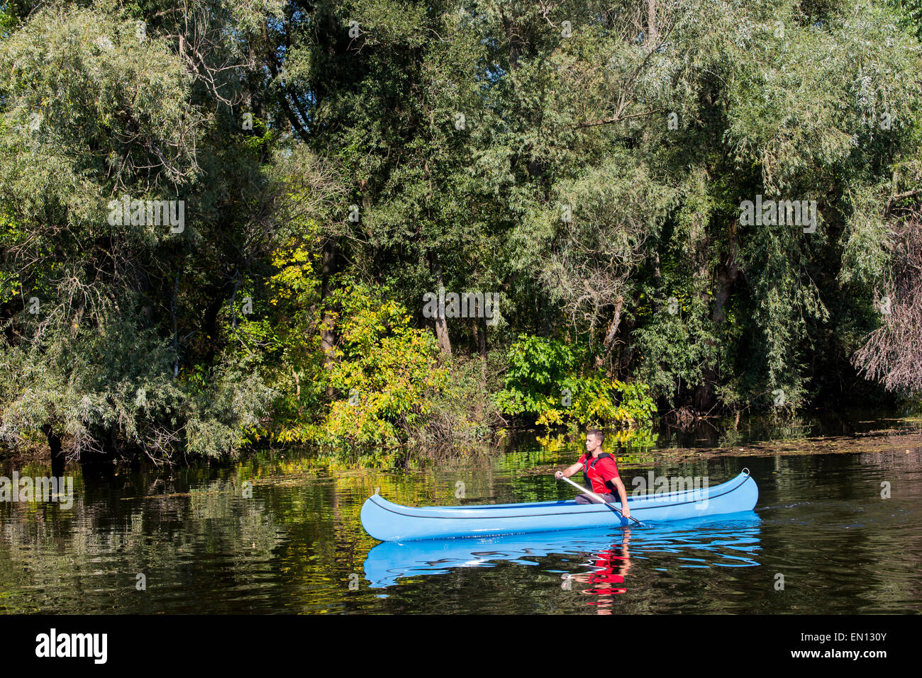Young man in canoe Stock Photo - Alamy