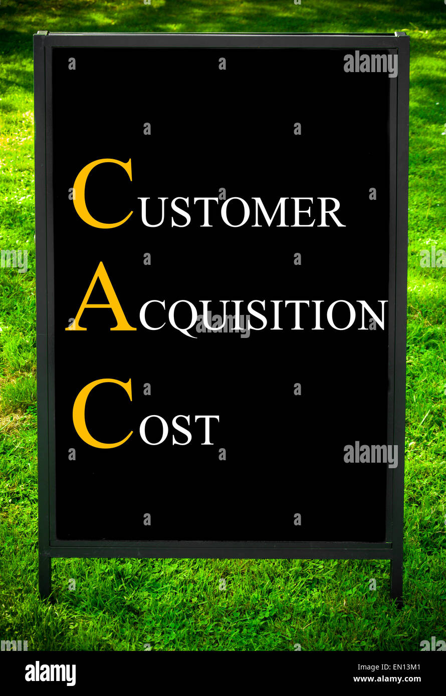 Business Acronym CAC as CUSTOMER ACQUISITION COST. Message on sidewalk