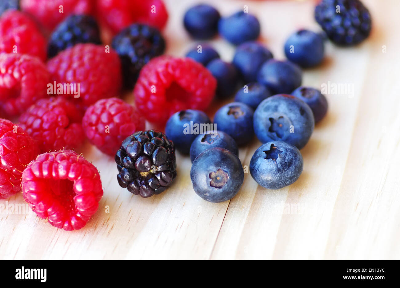 ripe blackberries, raspberries and blueberries on table Stock Photo Alamy