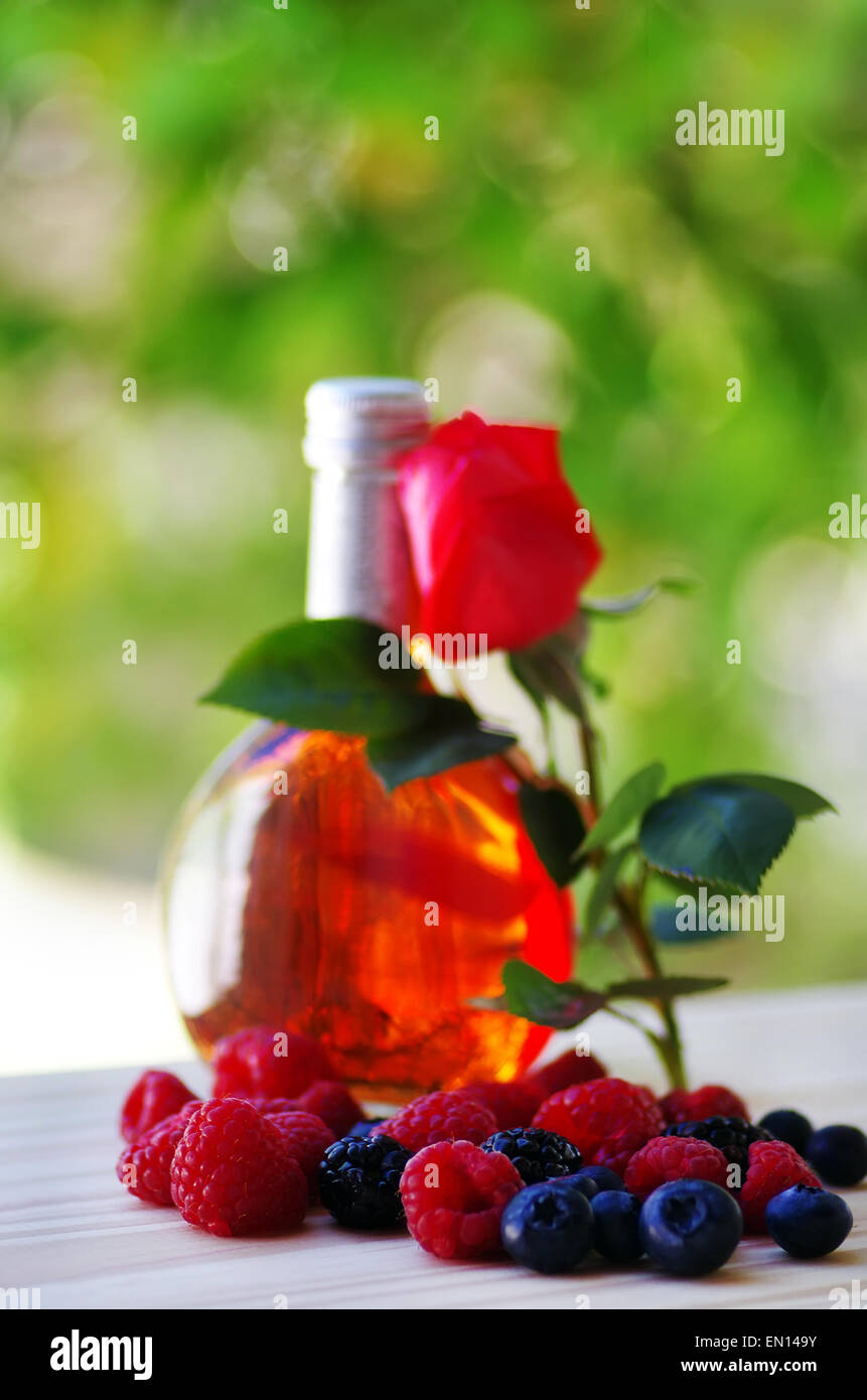 wine bottle, rose and fruits Stock Photo Alamy