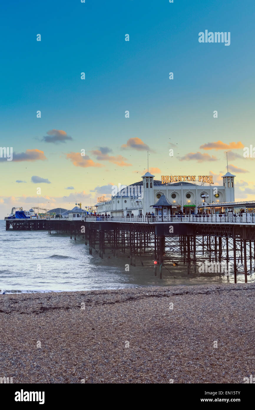 Europe, United Kingdom, England, East Sussex, Brighton, Brighton pier and beach, Palace pier, built in 1899, shoreline at dusk Stock Photo