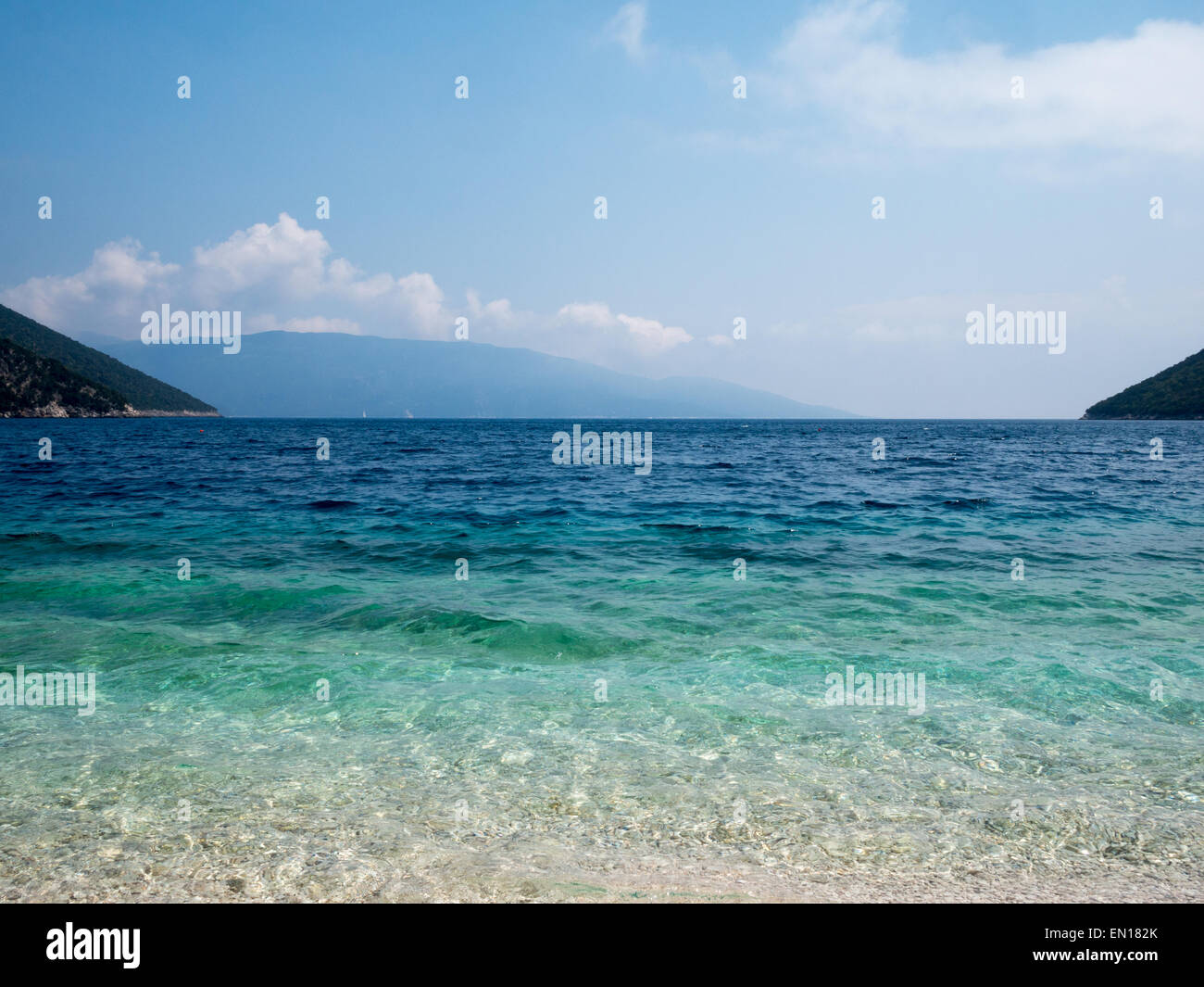Antisamos beach turquoise waters and the mountains in the horizon Stock Photo