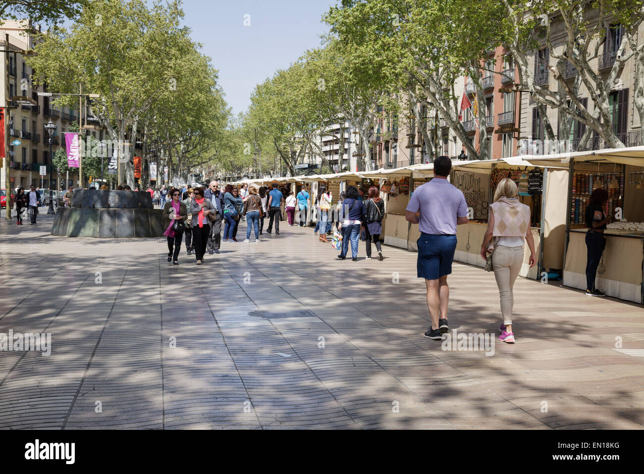 people walking on La Rambla with art and souvenir stalls, Barcelona, Catalonia, Spain Stock Photo