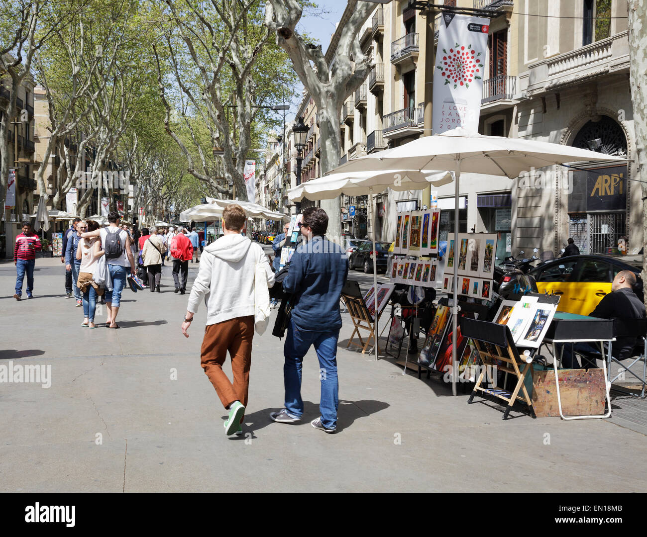 people walking on La Rambla by an artist stall, Barcelona, Catalonia, Spain Stock Photo