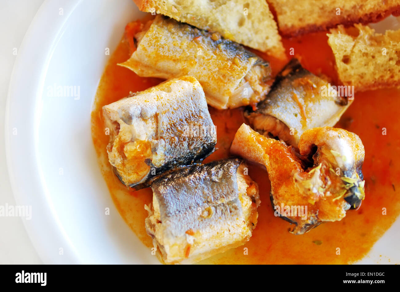 eel stew with tomato and toasted bread Stock Photo