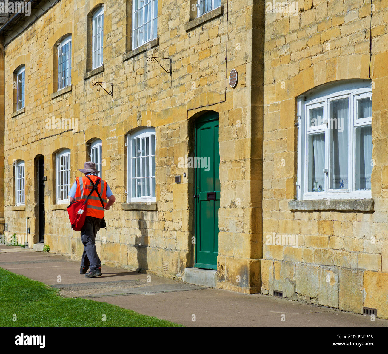 Postman delivering mail in Chipping Campden, Gloucerstershire, Cotswolds, England UK Stock Photo