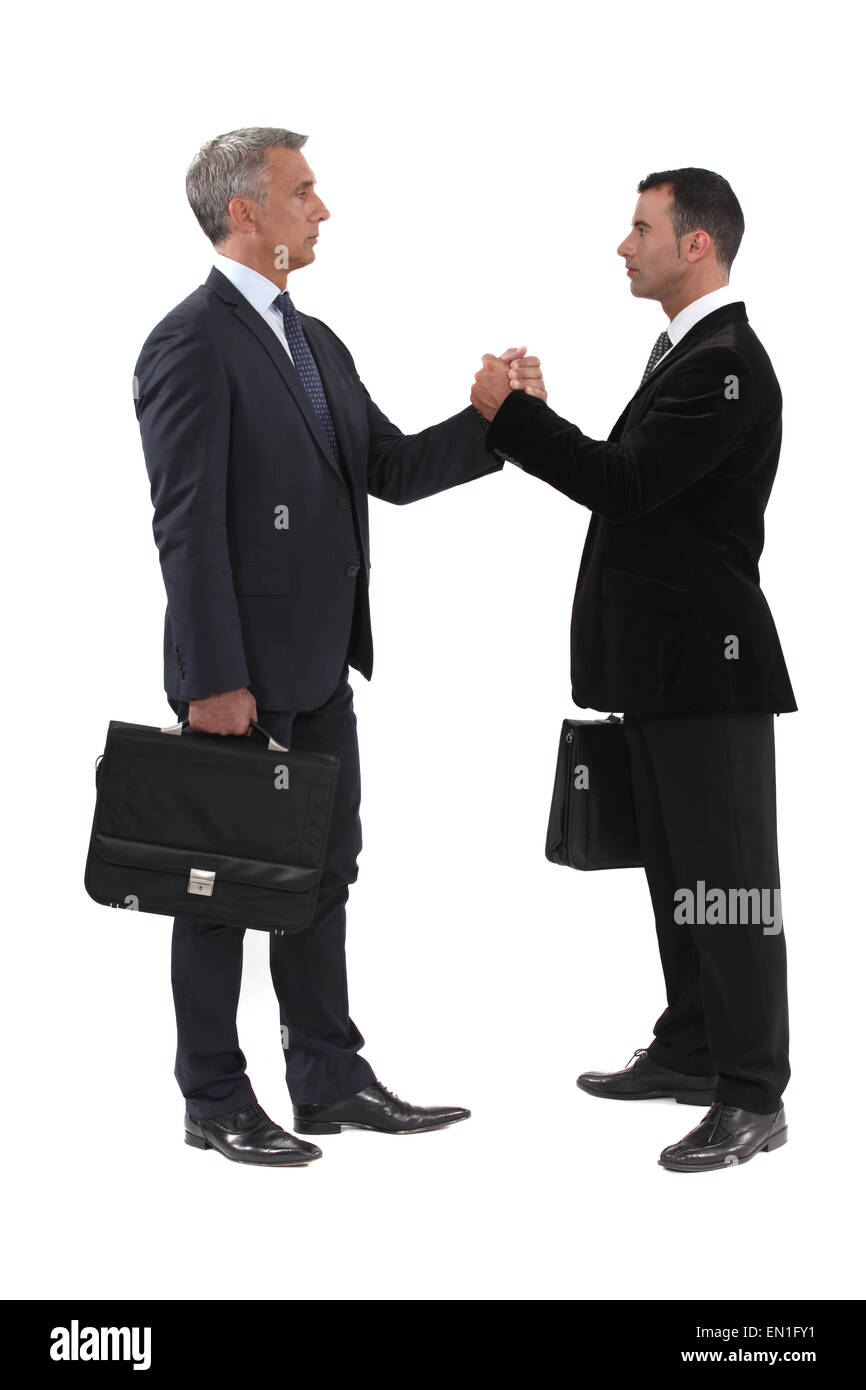 Businessmen gripping hands Stock Photo Alamy