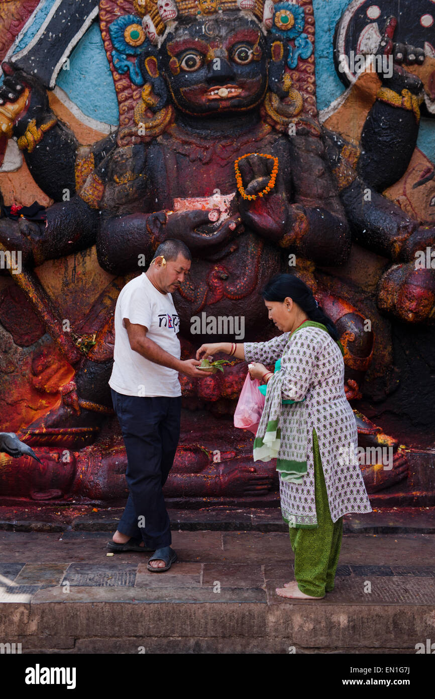 Woman offering to lord Shiva in Durbar Square Stock Photo