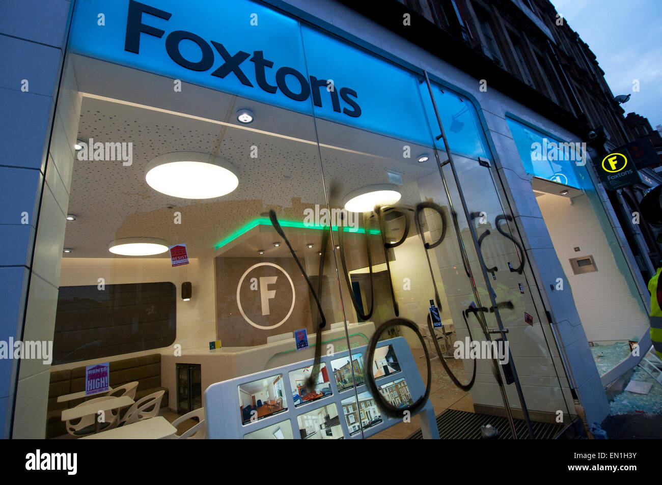 Foxtons Estate Agents window smashed and riot police using tear gas vandalised after Reclaim Brixton event April 25th 2015 Stock Photo