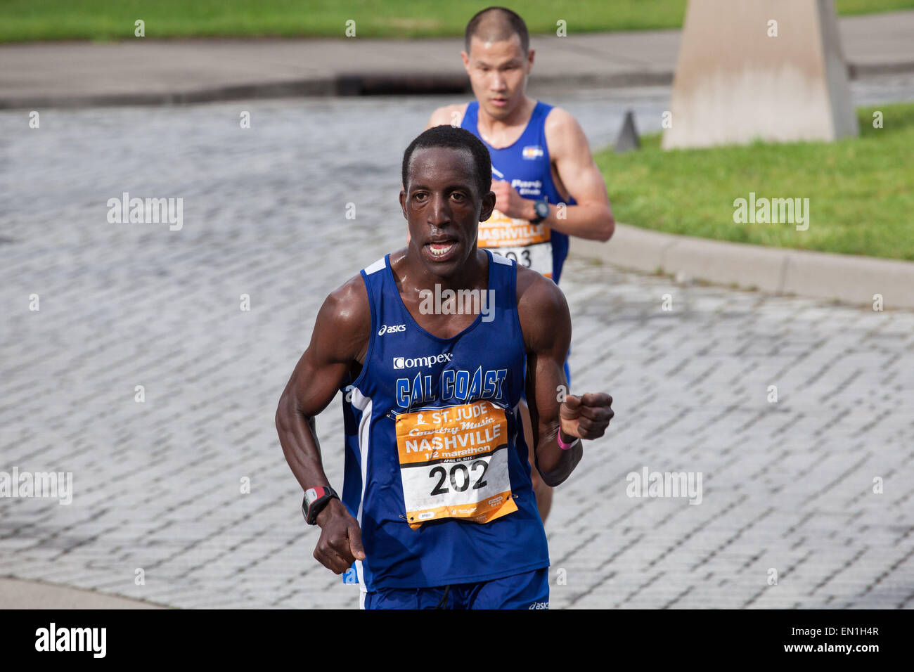 Nashville, Tennessee, USA. 25th Apr, 2015. ROOSEVELT COOK (front, bib number 202) overtakes STEVE CHU (right, bib number 203) during the final stretch of the St. Jude Country Music Half Marathon in Nashville. © Raffe Lazarian/ZUMA Wire/ZUMAPRESS.com/Alamy Live News Stock Photo