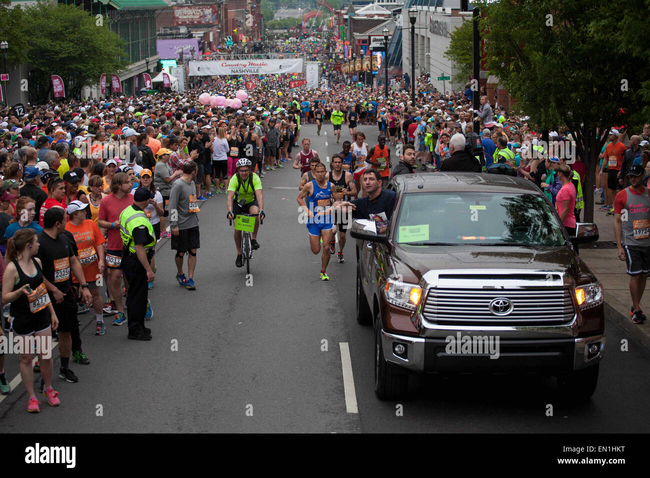 Nashville, Tennessee, USA. 25th Apr, 2015. Race staff clears people from the road as STEVE CHU (center, bib number 203) takes the lead during the St. Jude Country Music Marathon & Half Marathon in Nashville. © Raffe Lazarian/ZUMA Wire/ZUMAPRESS.com/Alamy Live News Stock Photo