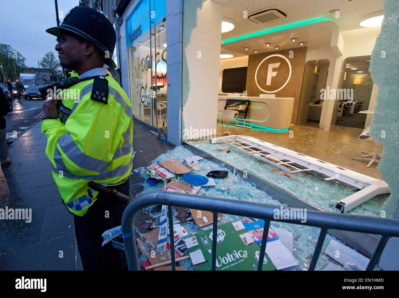 Foxtons Estate Agents window smashed and riot police using tear gas vandalised after Reclaim Brixton event April 25th 2015 Stock Photo