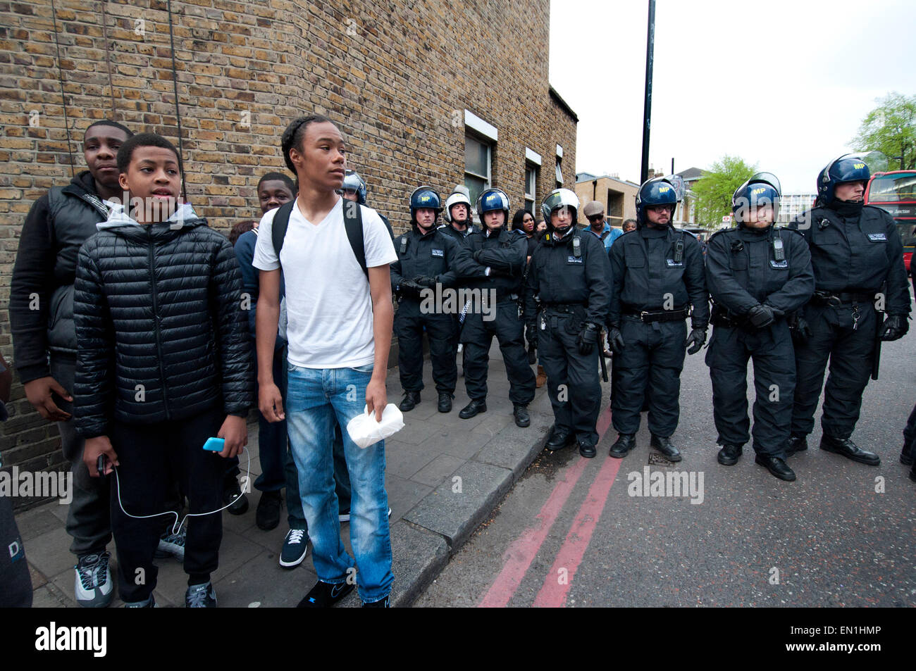 Group of lads in Brixton with riot Police called in to Brixton following reclaim Brixton event Stock Photo