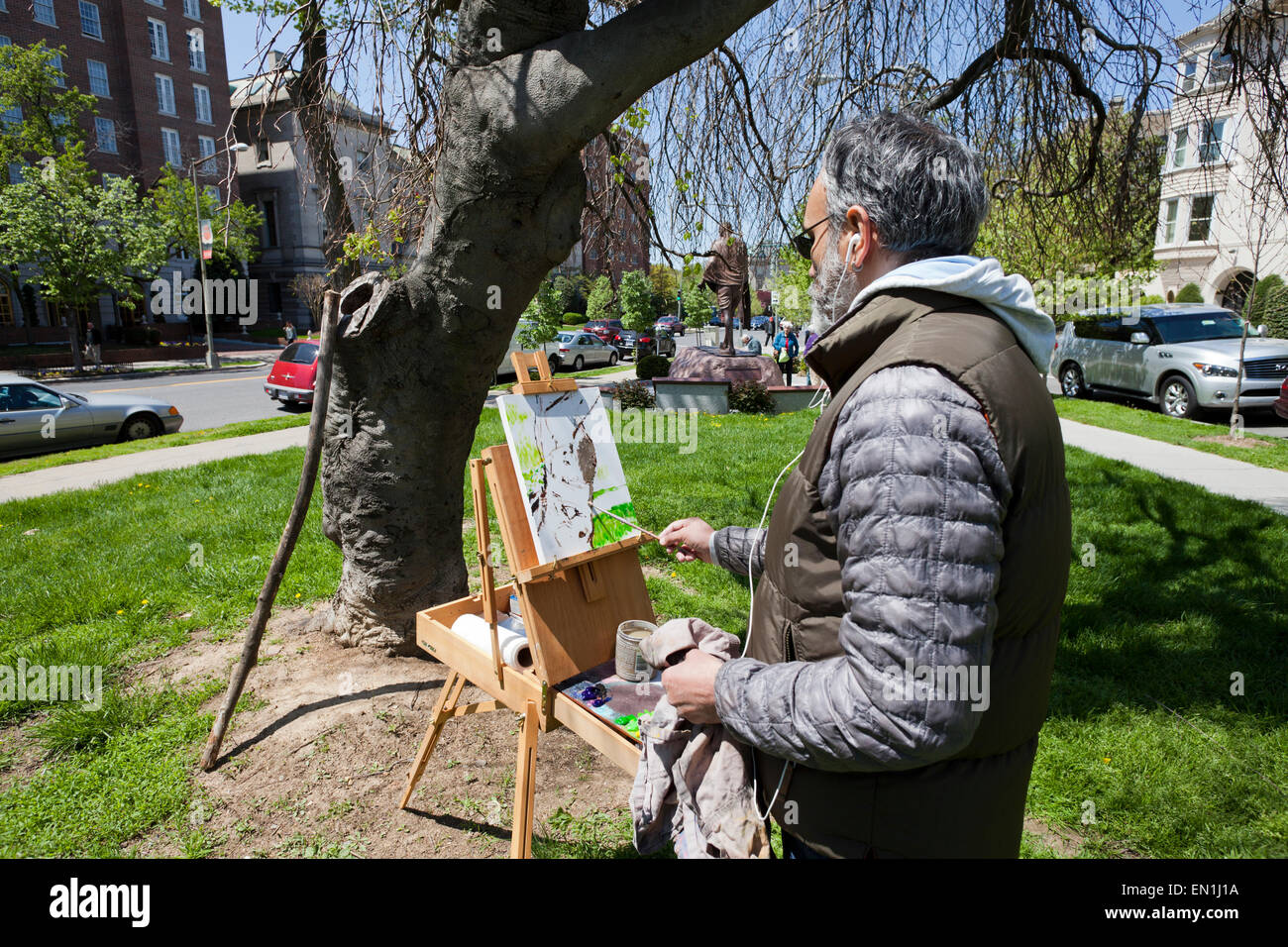 man painting a picture in urban park - USA Stock Photo