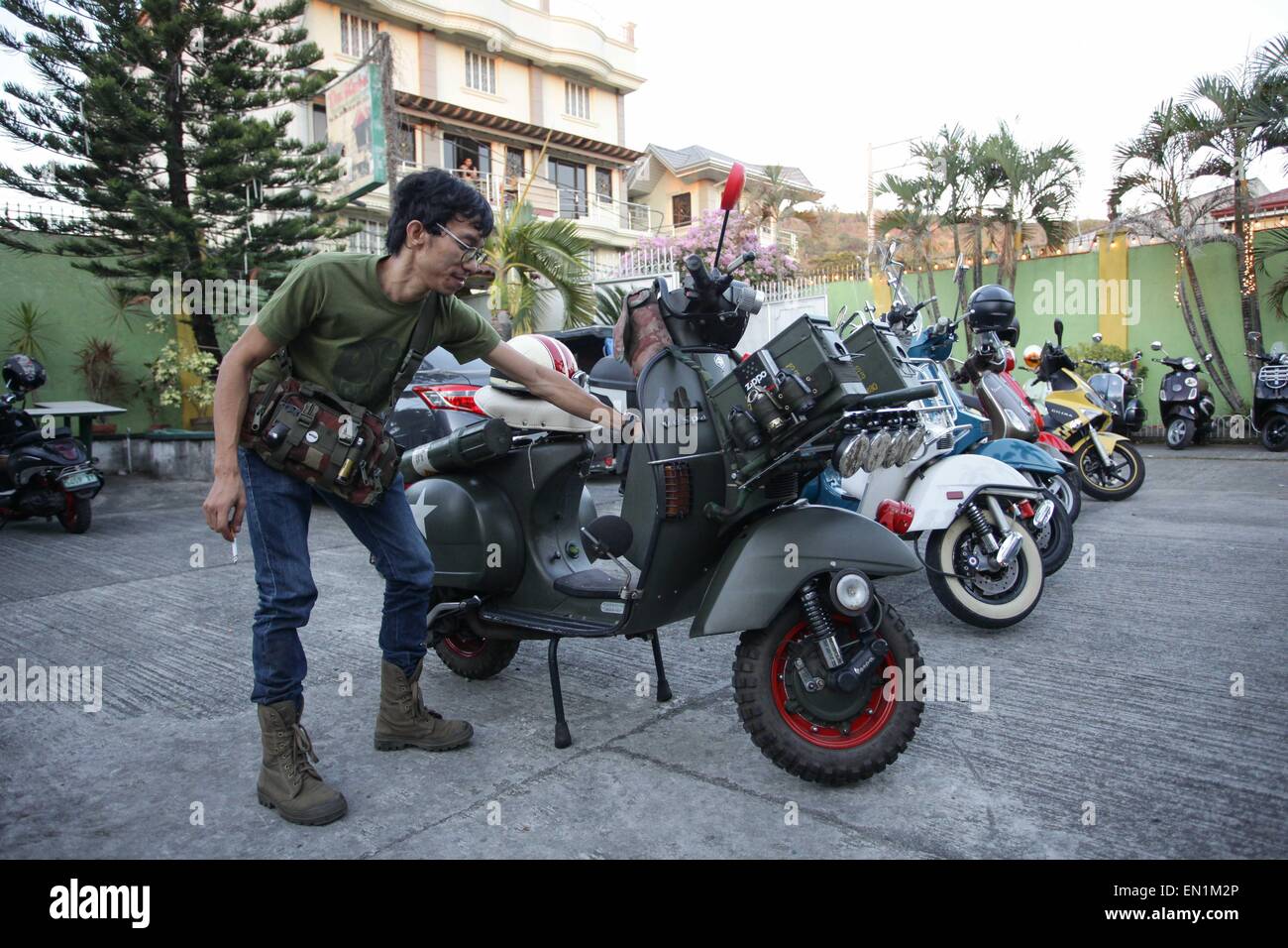 Metro Manila, Philippines. 25th Apr, 2015. Rommel Figueroa checks his army themed scooter during the 9th Scooter Jamboree in Angono, Rizal on Saturday, the Art Capital of the Philippines annually hosts the Scooter Jamboree, a gathering of European scooter enthusiasts in Metro Manila. © Mark Cristino/Pacific Press/Alamy Live News Stock Photo