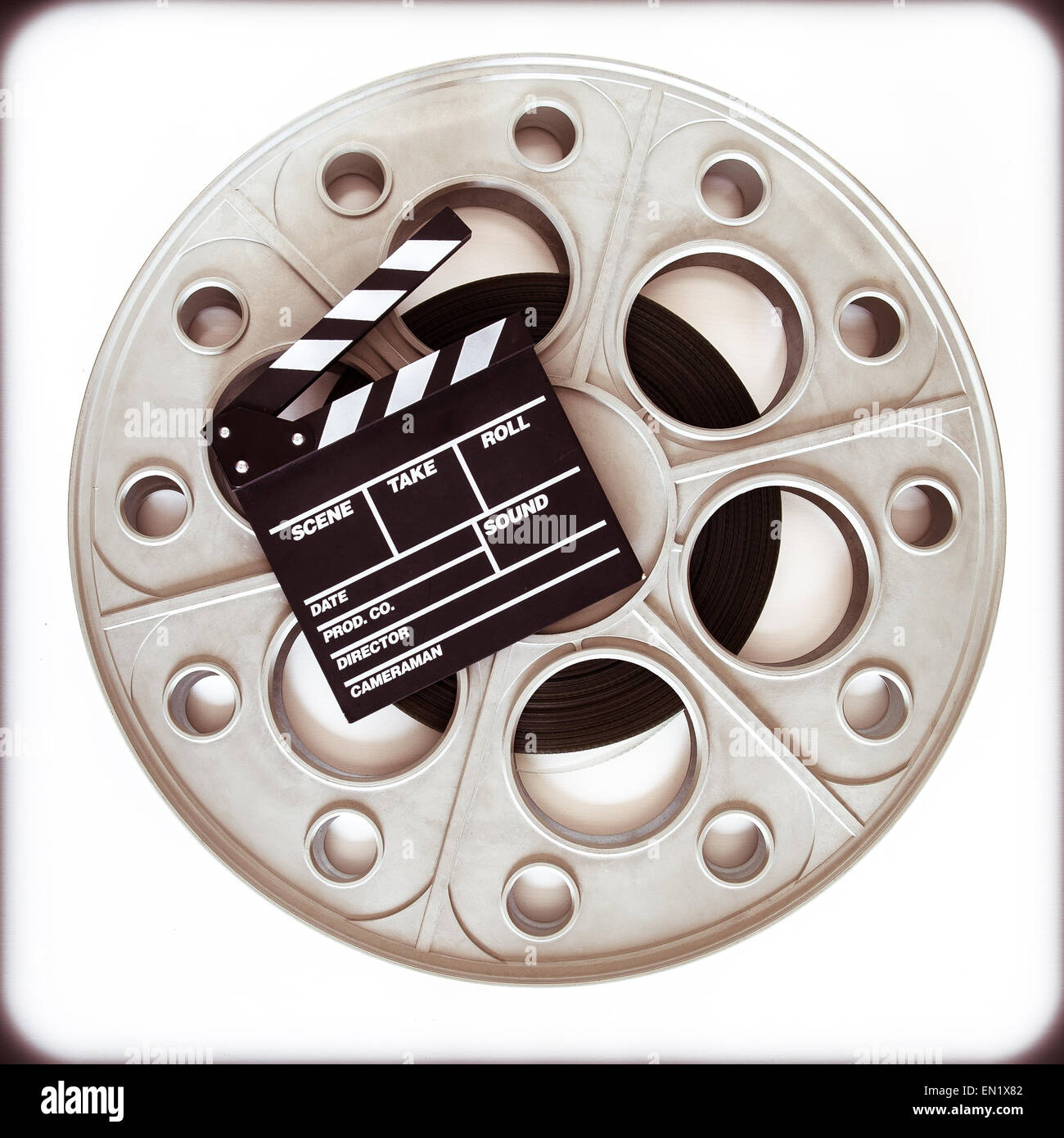 Original old big movie reel for 35 mm cinema projector loaded with film,  with clapper board on neutral background vintage color Stock Photo - Alamy