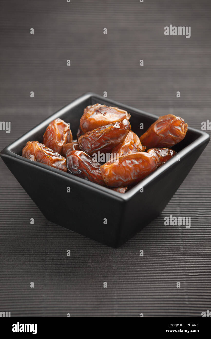 Dried dates in a bowl Stock Photo