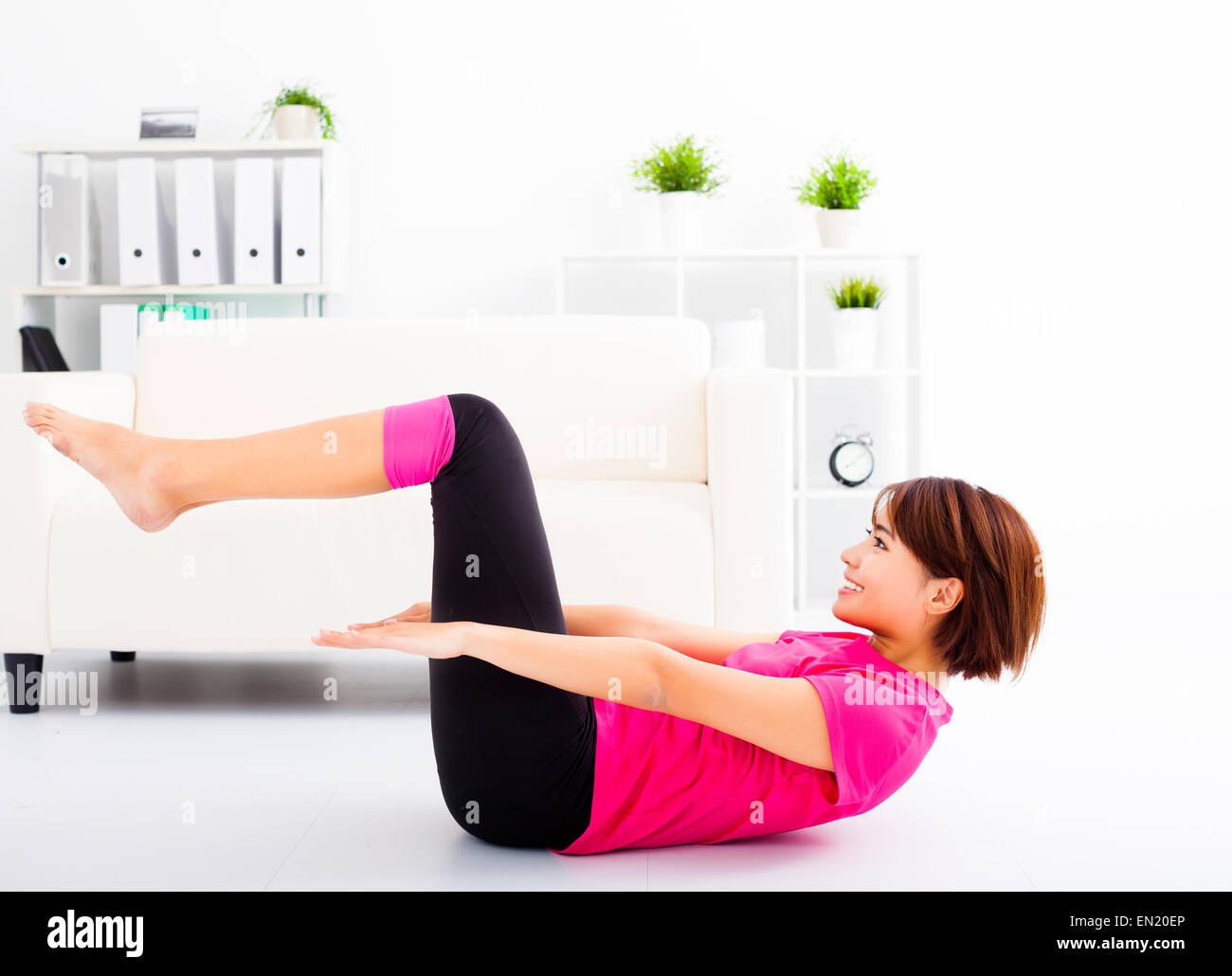 beautiful young woman stretching on the floor Stock Photo - Alamy