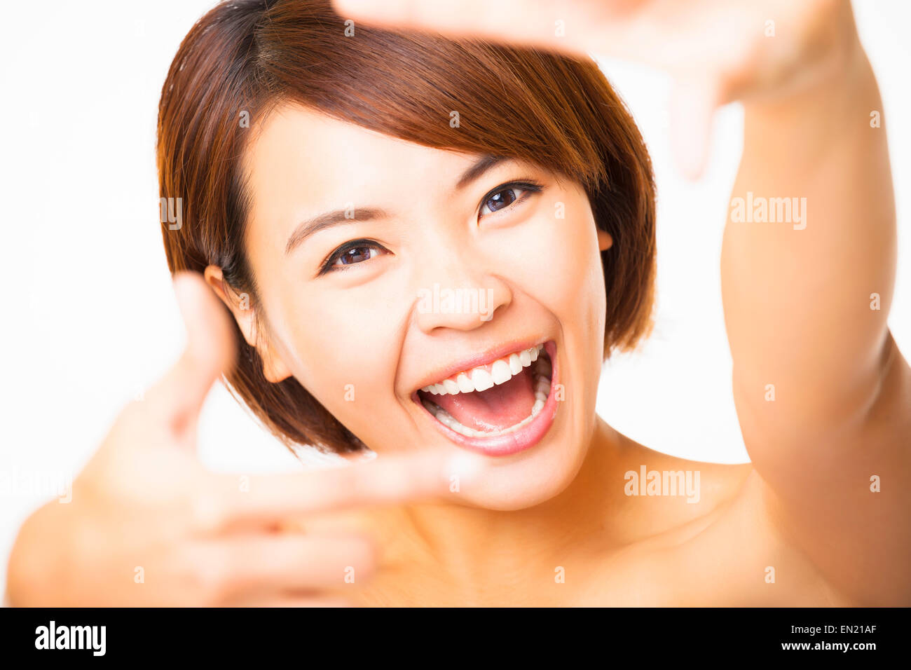 happy young Woman showing frame finger sign Stock Photo