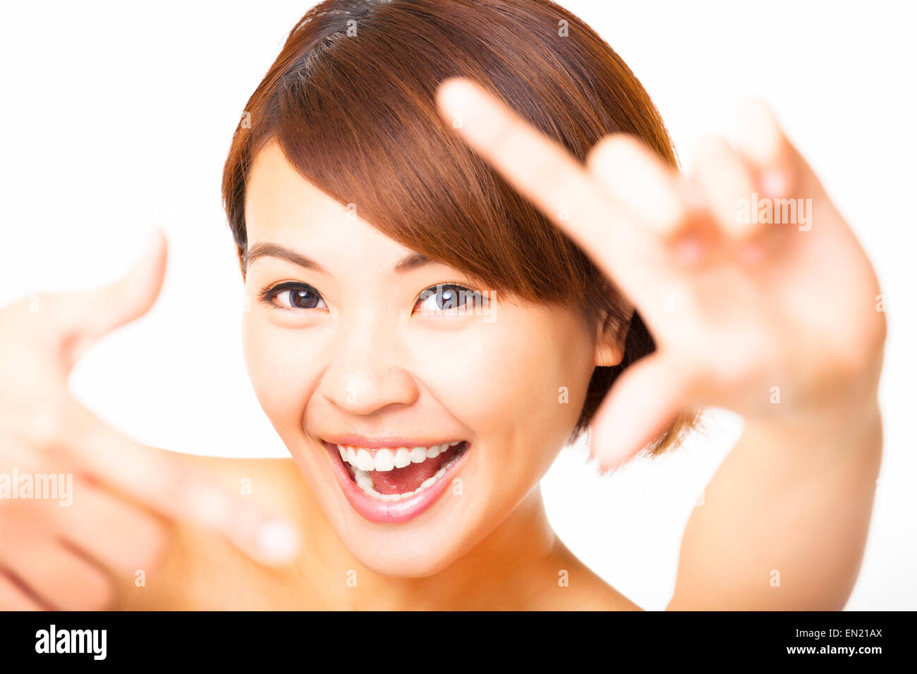 happy young Woman showing frame finger sign Stock Photo