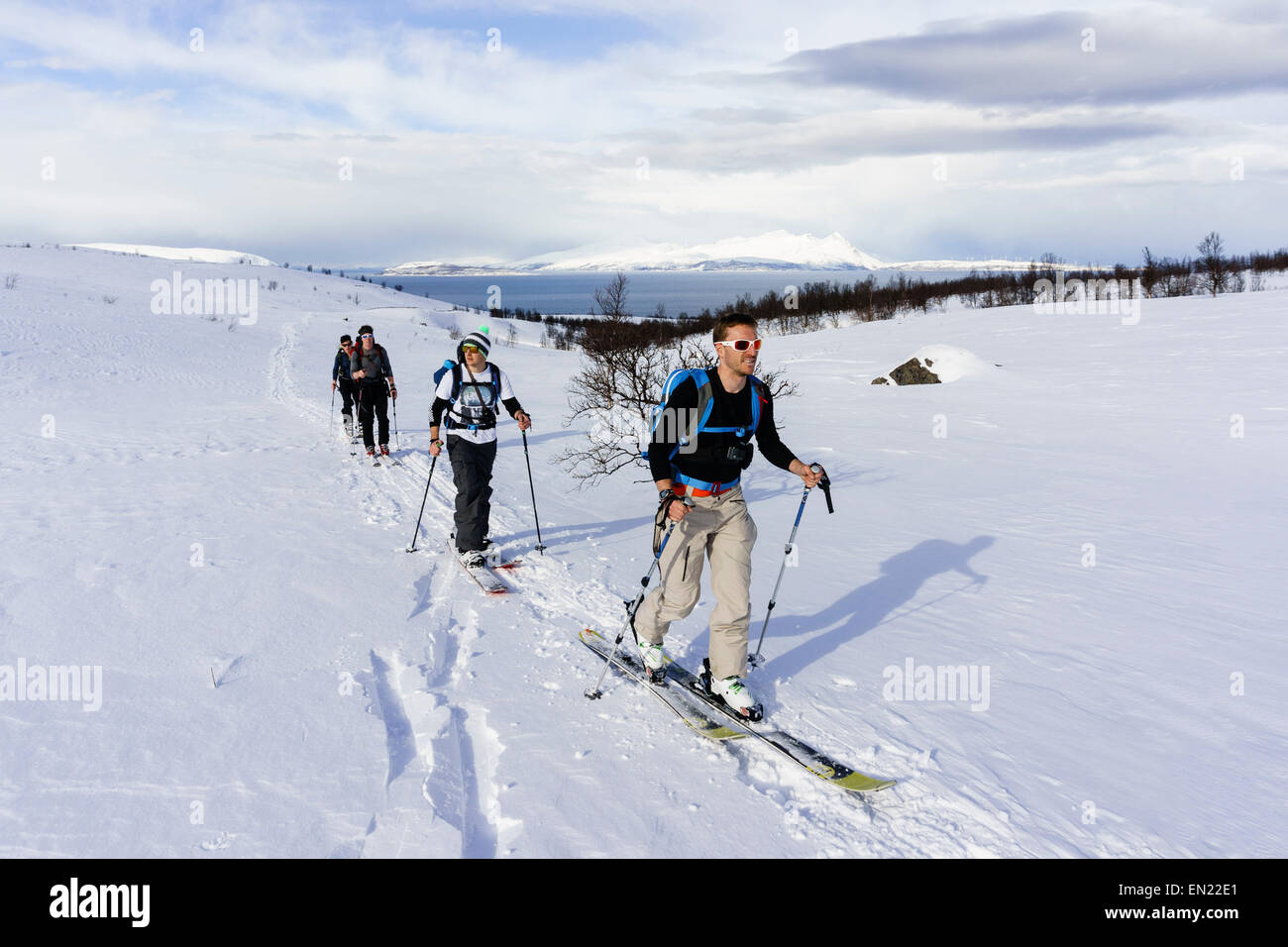 Men ski touring using skins on the route up Russelvfjellet mountain