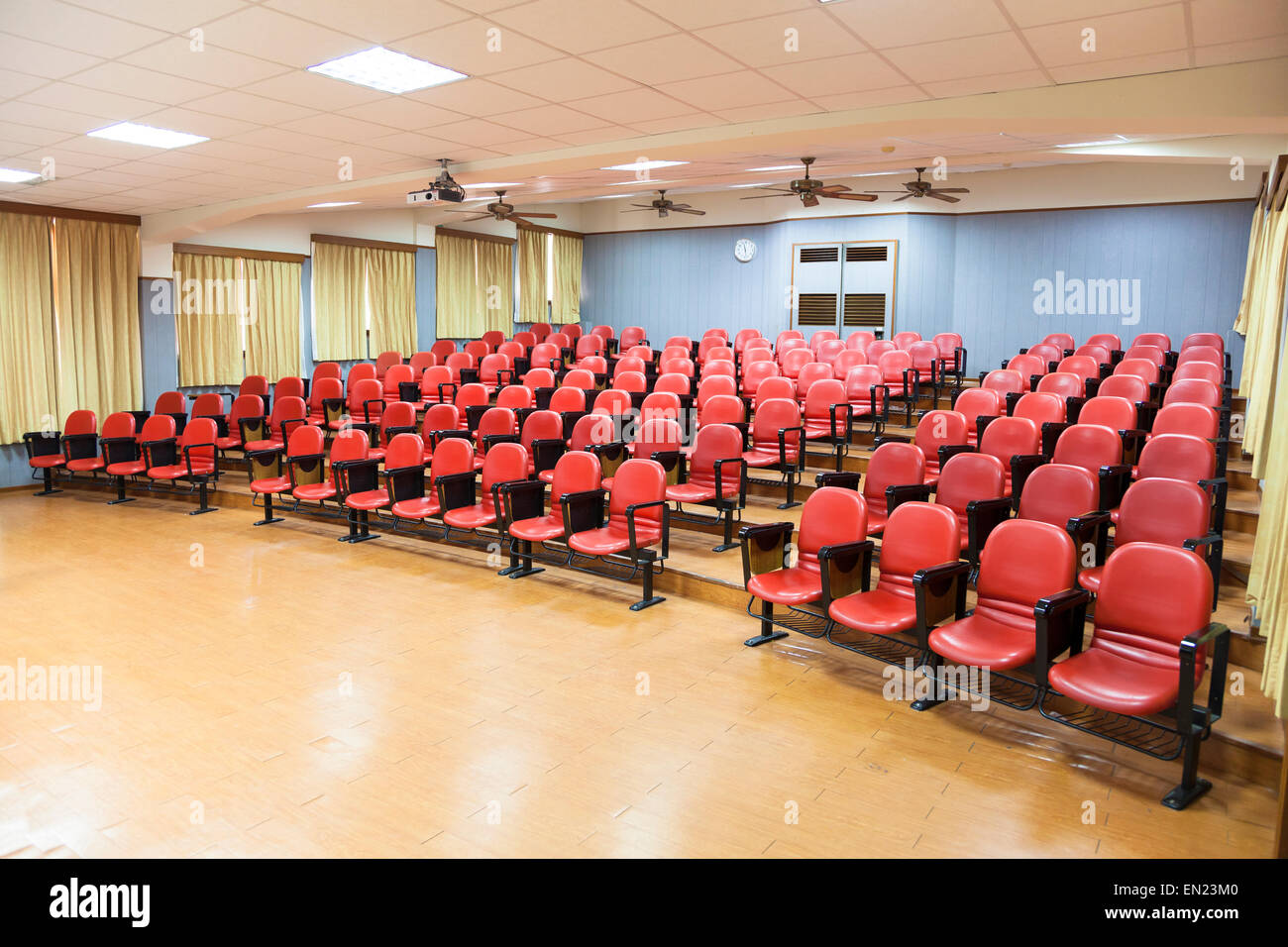 Interior of empty conference hall with red chairs Stock Photo