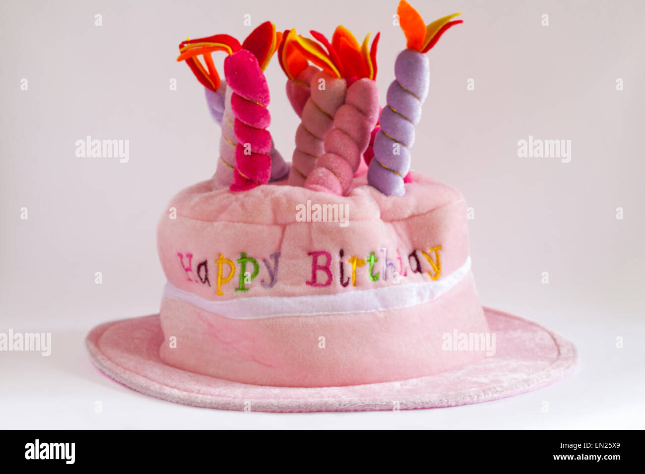 Happy Birthday novelty hat with candles on top isolated on white