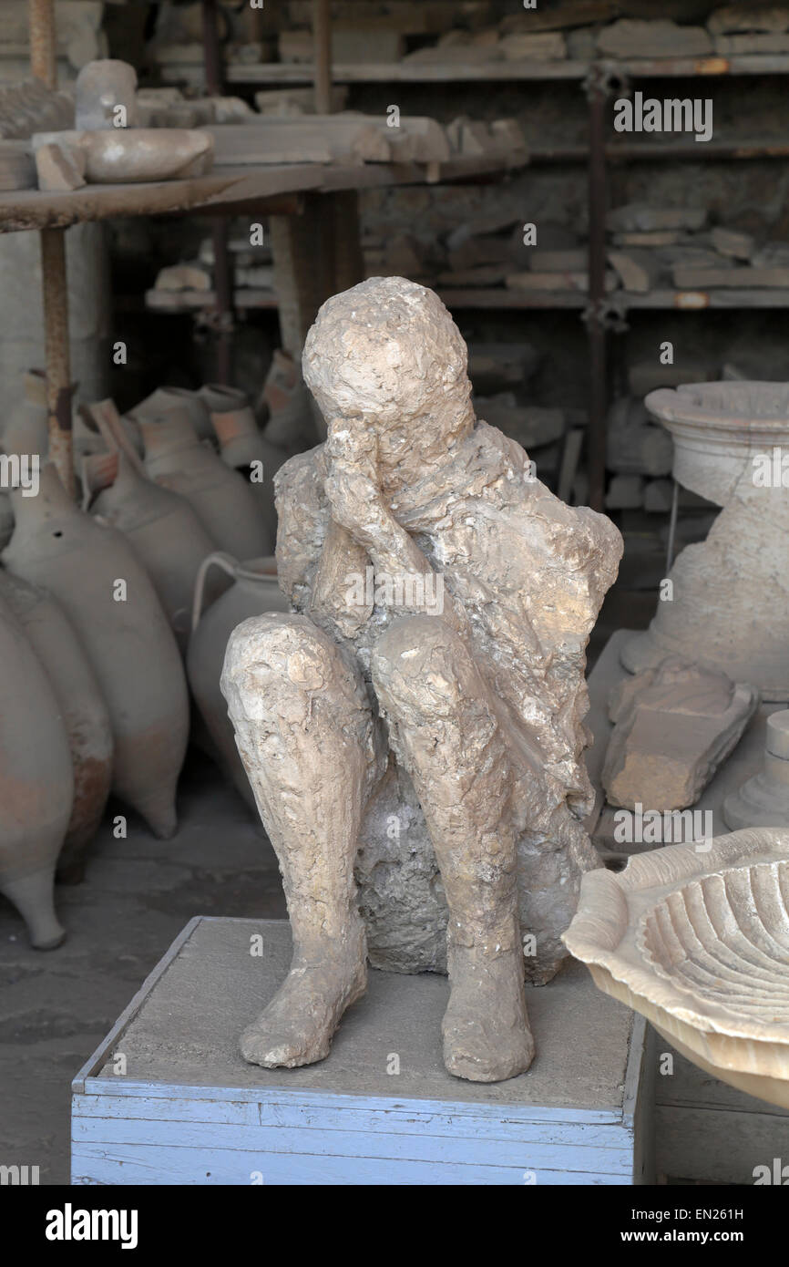 Crouched body plaster cast in the Granary, Pompeii, Italy. Stock Photo