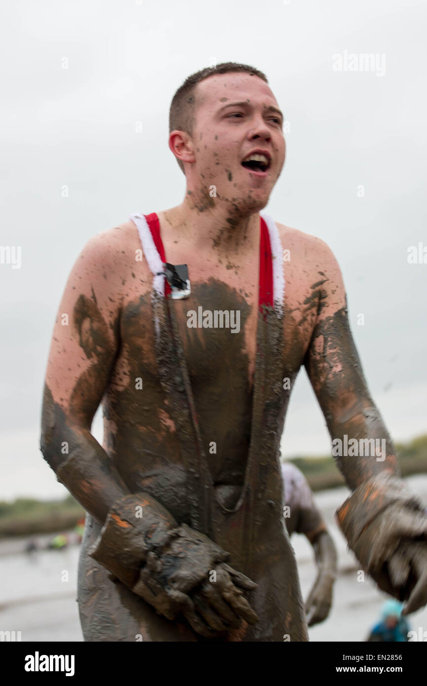 Maldon, Essex, 26 Apr, 2015.  Mud covered competitor makes it to the  finish line at the annual Maldon mud race. Credit:  darren Attersley/Alamy Live News Stock Photo