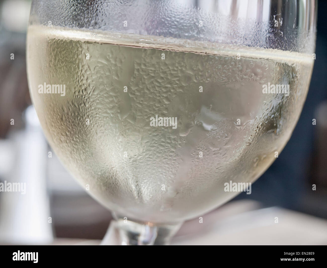 Close up of cold white wine in a glass with condensed  water droplets on the outside Stock Photo