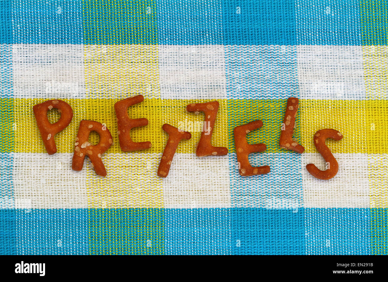 Word pretzels written with pretzellike letters on colorful cloth Stock