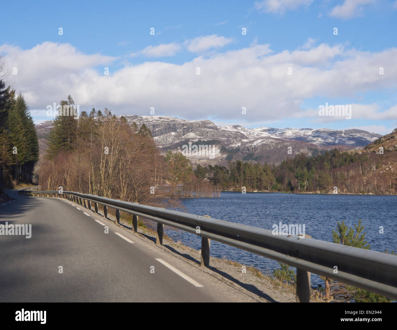 On the road in Ryfylke in the Norwegian fjords, early springtime, water, woods and mountains Stock Photo