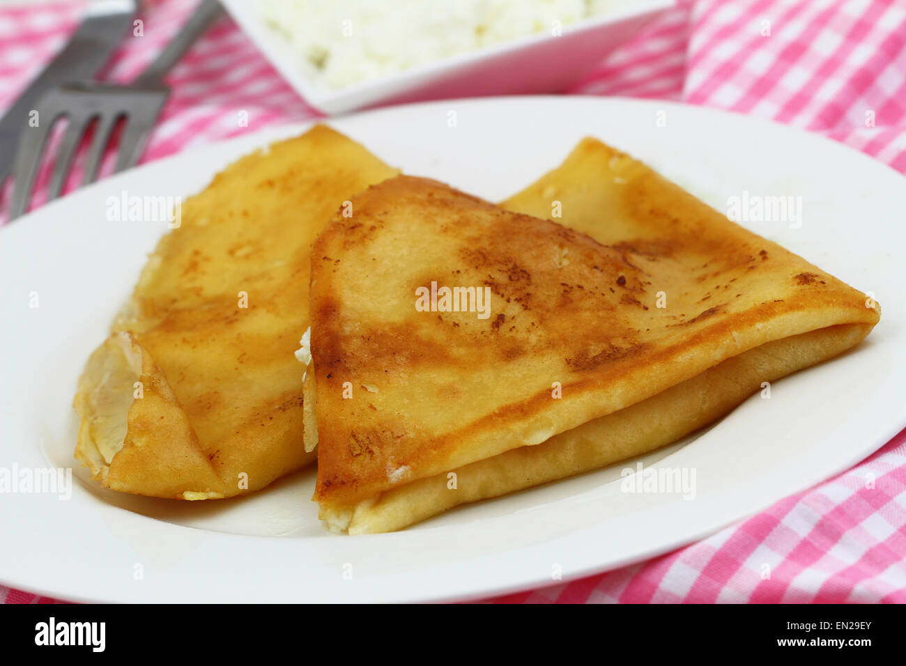 Crepes with cottage cheese on white plate Stock Photo