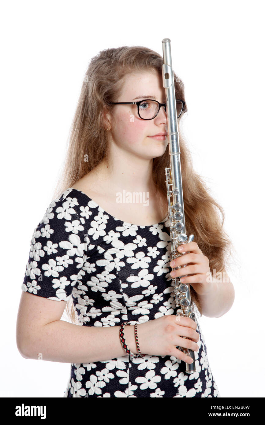 teenage girl stands pensive with flute against white background Stock Photo