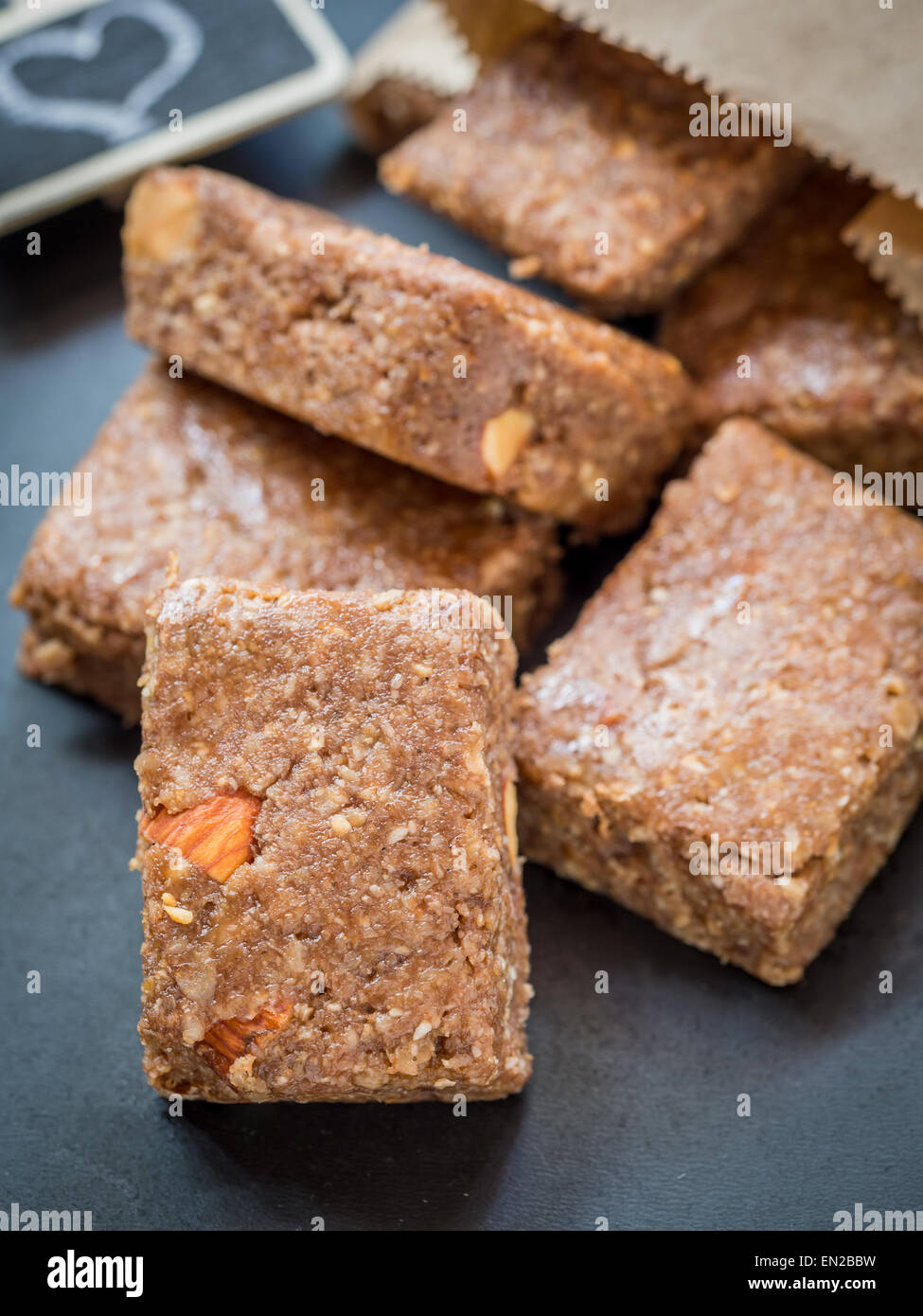 Homemade organic healthy chewy muesli granola power bars with wholemeal oats, cashew butter, honey and nuts, cut into bite size. Stock Photo