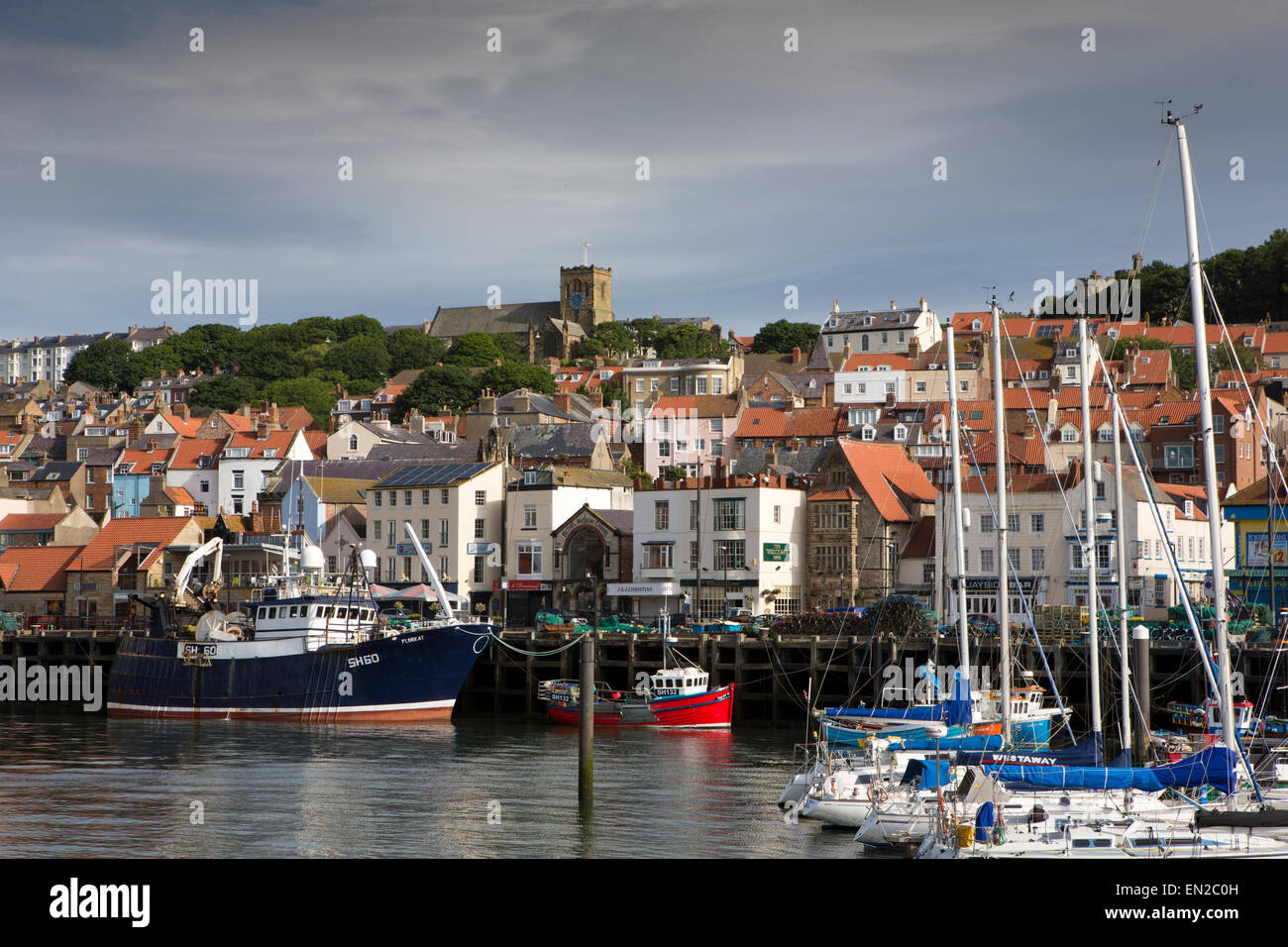 UK, England, Yorkshire, Scarborough, boats moored at Old Harbour quay below old town and St Mary’s church Stock Photo
