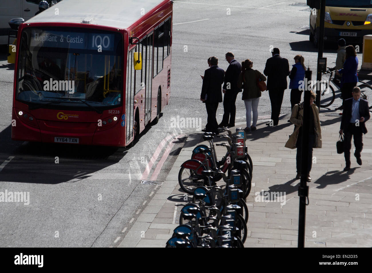 Transport in London Commuters cross busy street in Central London with