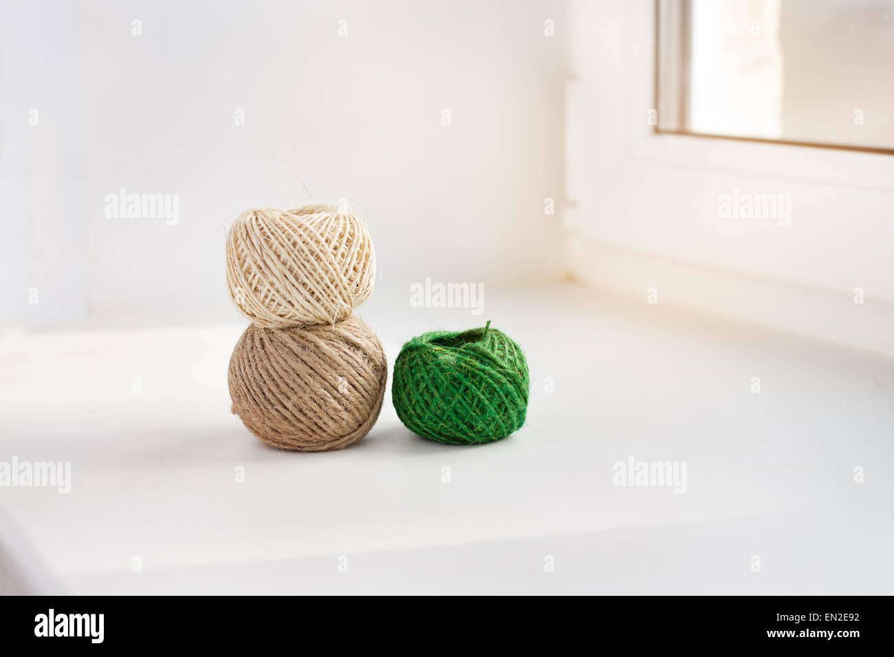 Skein of green and brown thread on a beige background Stock Photo by ndanko
