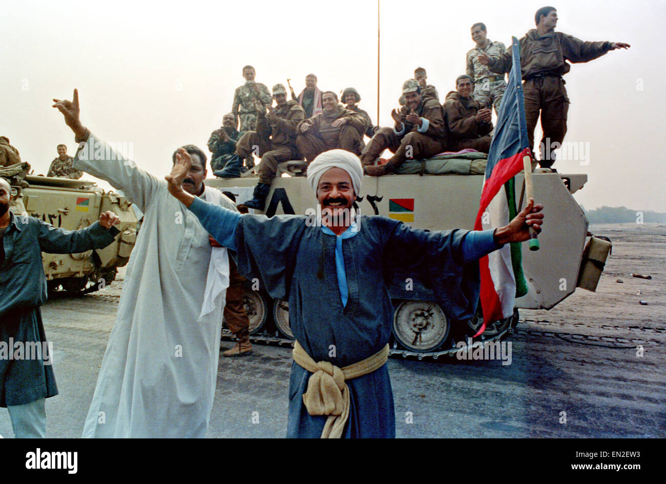 Kuwaiti men dance in the streets as Egyptian coalition forces join in