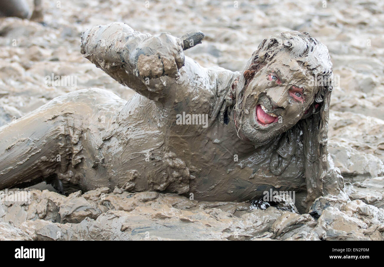 Maldon, Essex, 26 Apr, 2015. Competitor completely covered in mud and ...