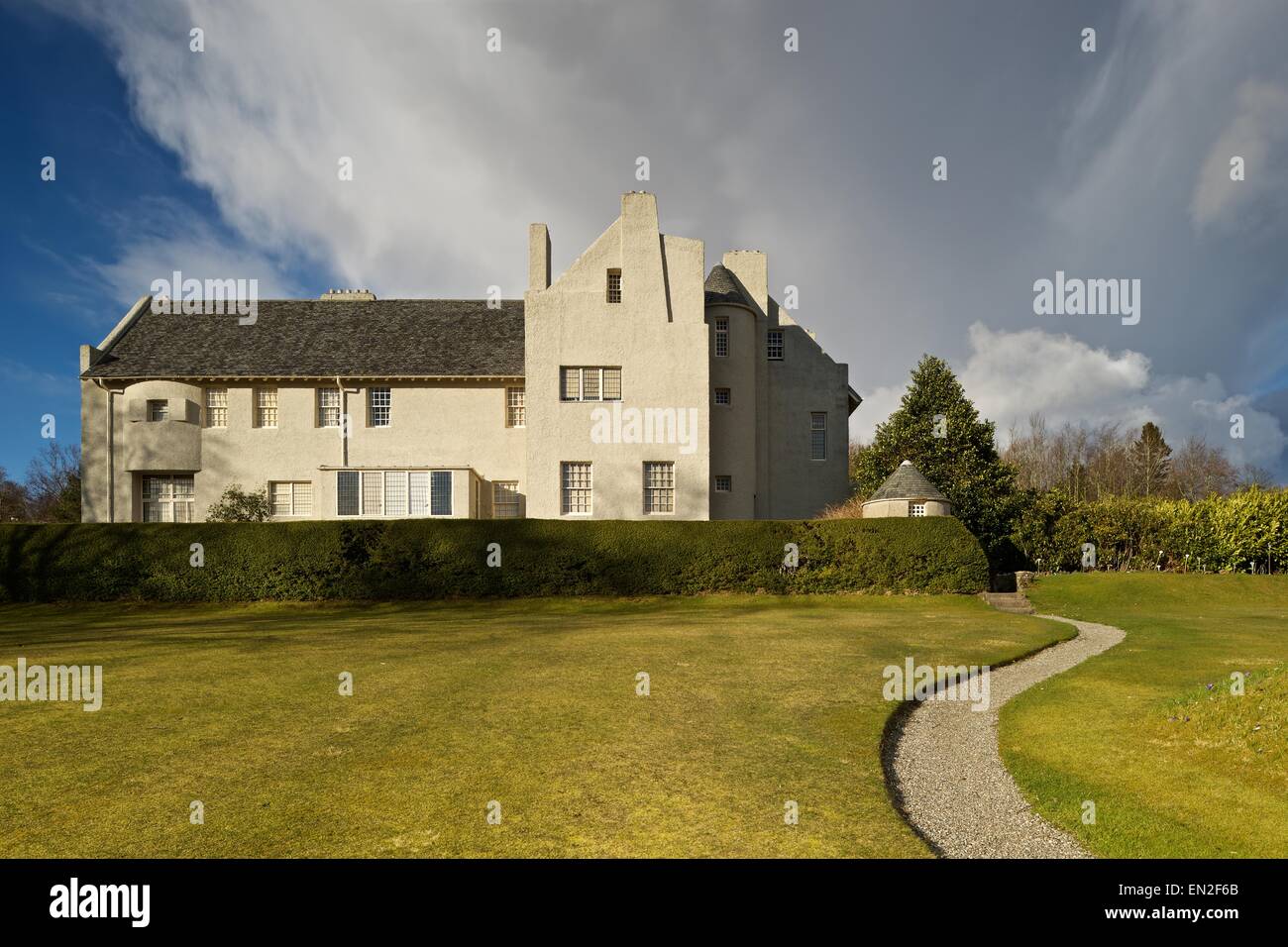 A colour image of Hill House in Helensburgh taken with a strong brooding cloud behind it Stock Photo