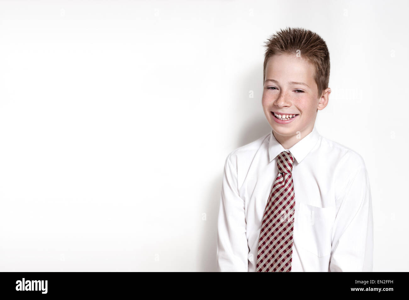 Emotional portrait of smiling boy with tie Stock Photo