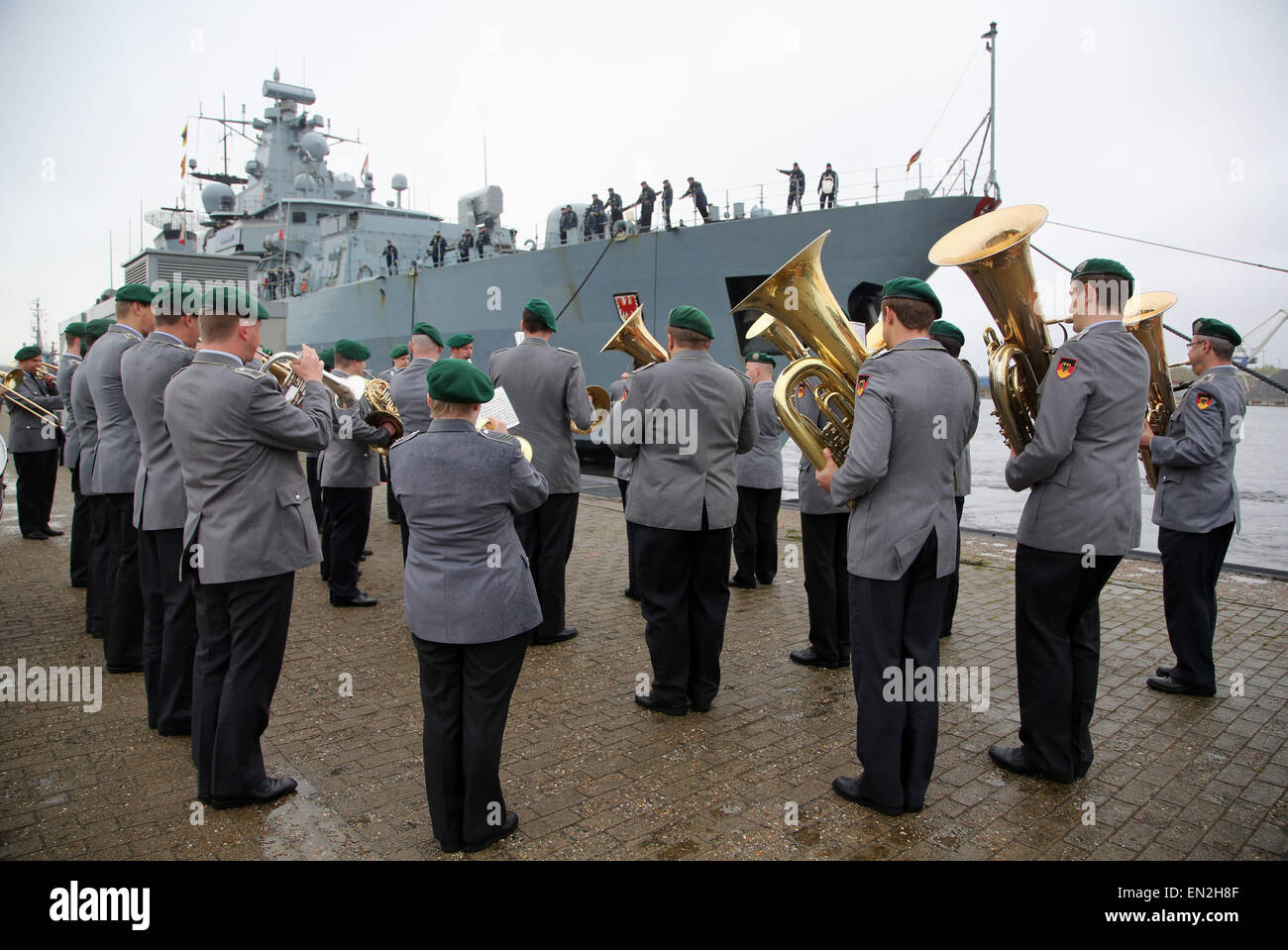 Wilhelmshaven, Germany. 26th Apr, 2015. A military band plays as the frigate F215 'Brandenburg' of the German Navy moores at its home port Wilhelmshaven, Northern Germany, on Sunday April 26, 2015. The vessels returns from a three-month journey during which it took part in the Obangame Express 2015 operation at the Gulf of Guinea. Credit:  Focke Strangmann/Alamy Live News Stock Photo