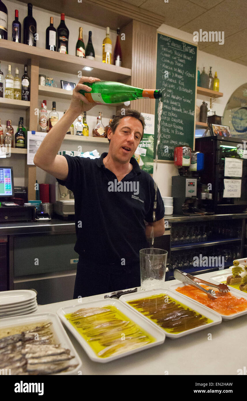 San Sebastian,Spain: man pouring a txakoli drink into a glass Stock Photo