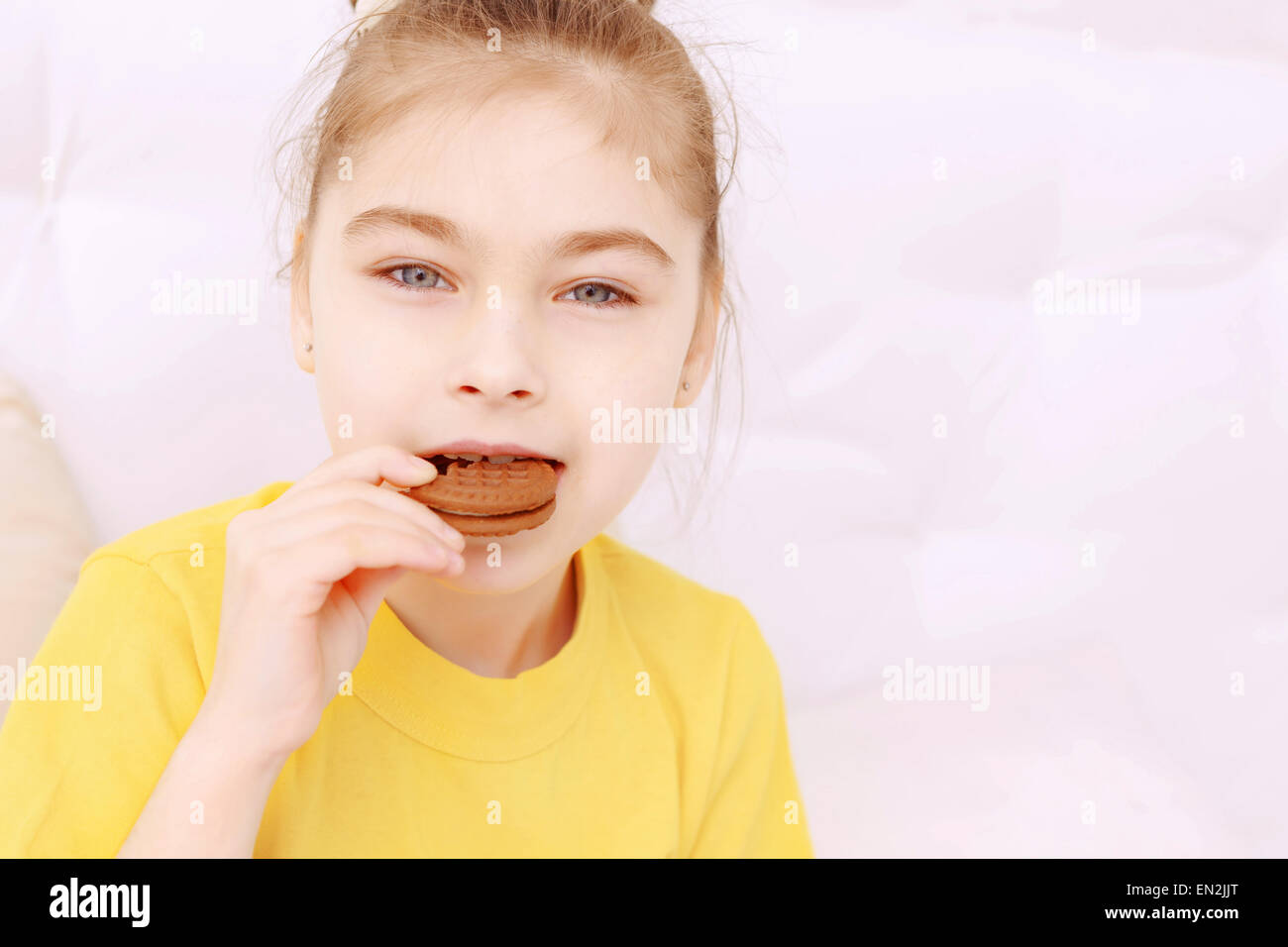 Pretty little girl eating cookie Stock Photo Alamy