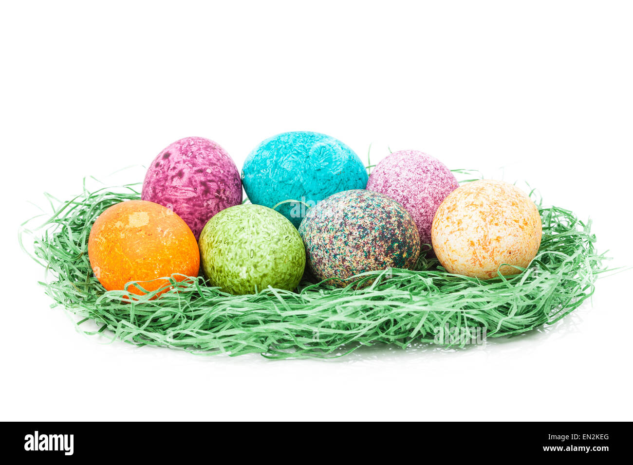 Colorulf easter eggs nest isolated on white background Stock Photo - Alamy