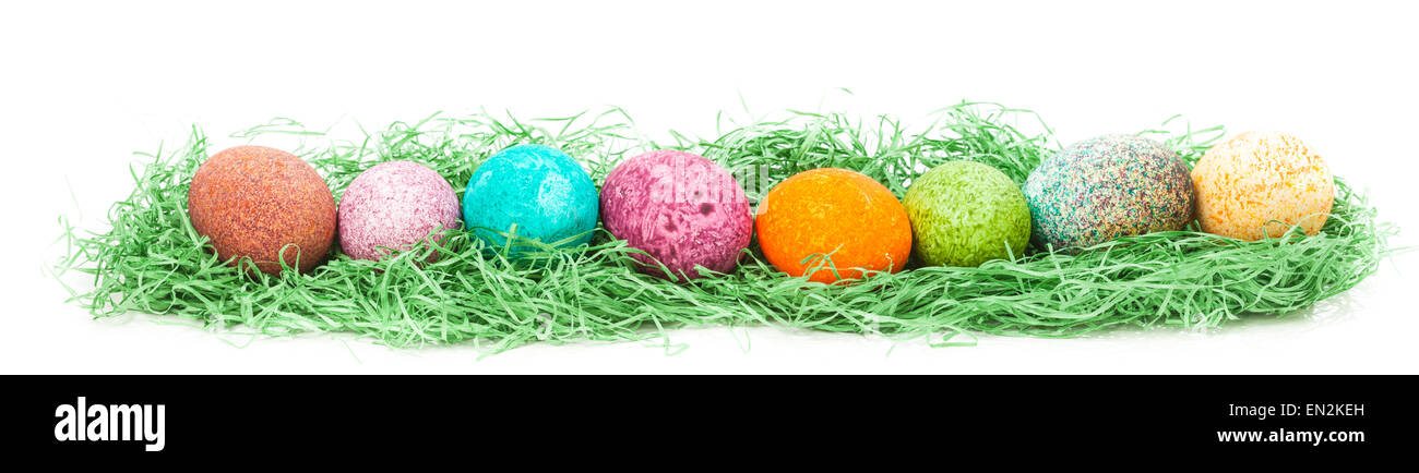 Colorulf easter eggs nest isolated on white background Stock Photo - Alamy